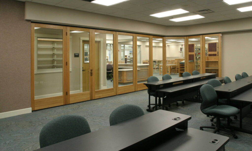 Luminous Mata wood framed glass insert movable wall, organic beauty of wood plus the clear viewing of glass. Individual or paired panel configurations to separate spaces in classroom setting